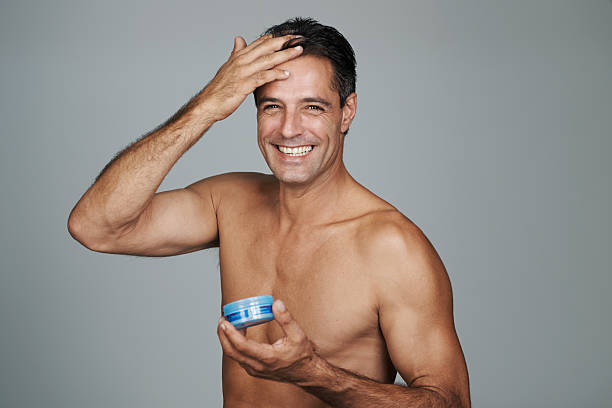 Cropped portrait of a handsome mature man styling his hair with gel